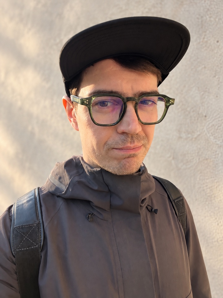 Alexander Lozhkin wearing a cap and glasses