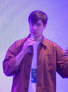 Alexander speaking at a conference